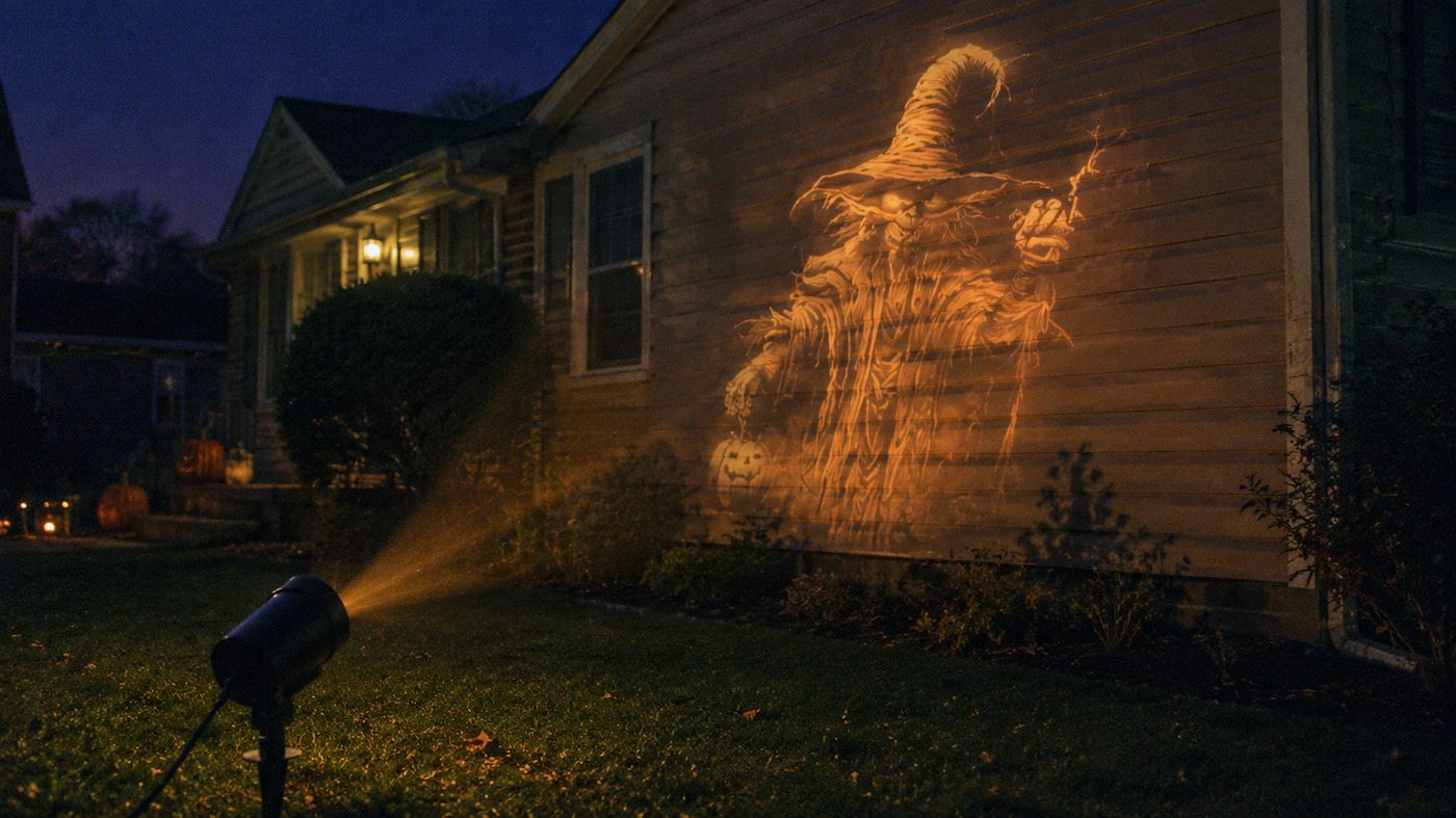 Scarecrow scene projected on a house wall at night