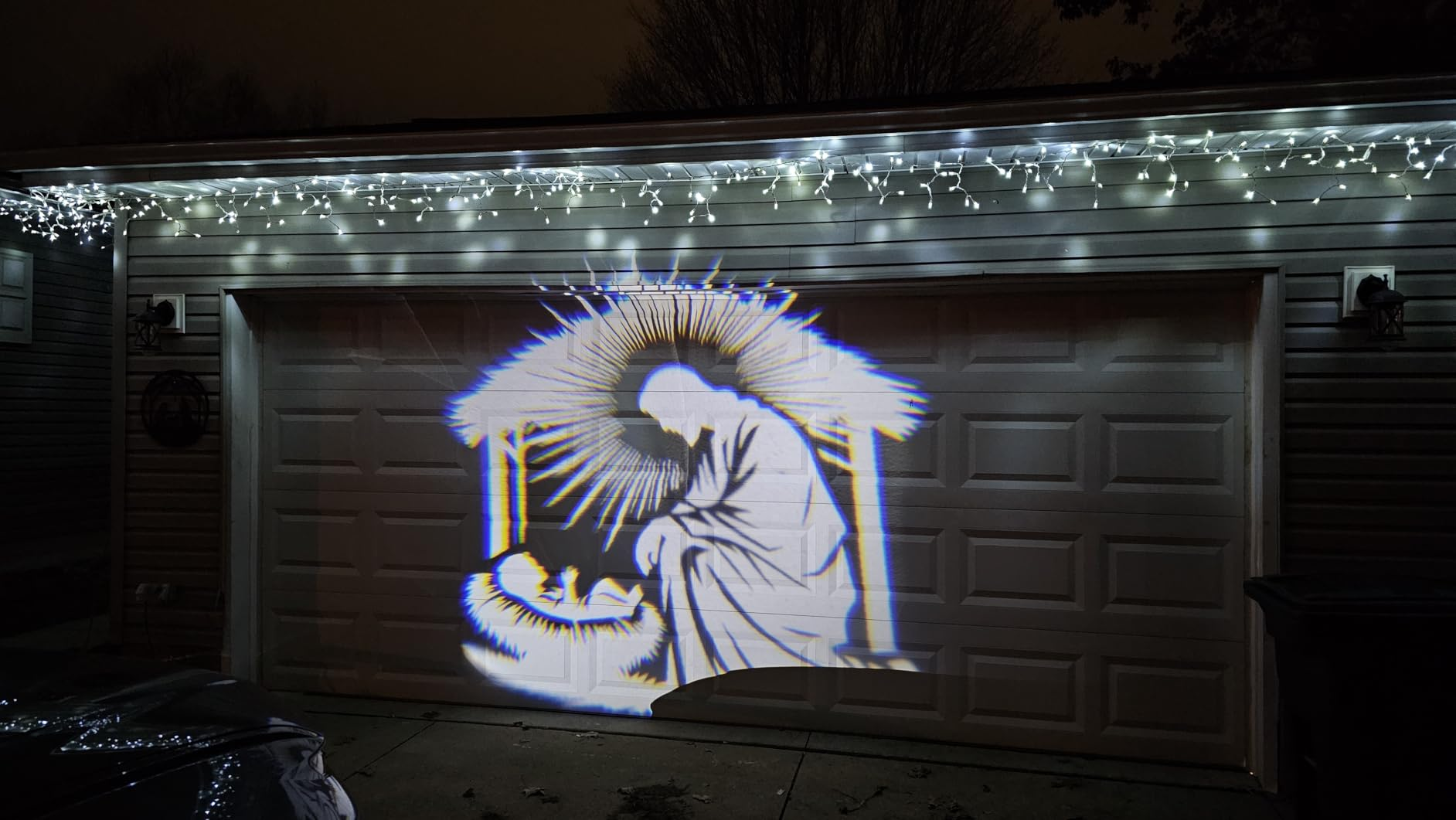 Christmas nativity scene projected on a customer's garage